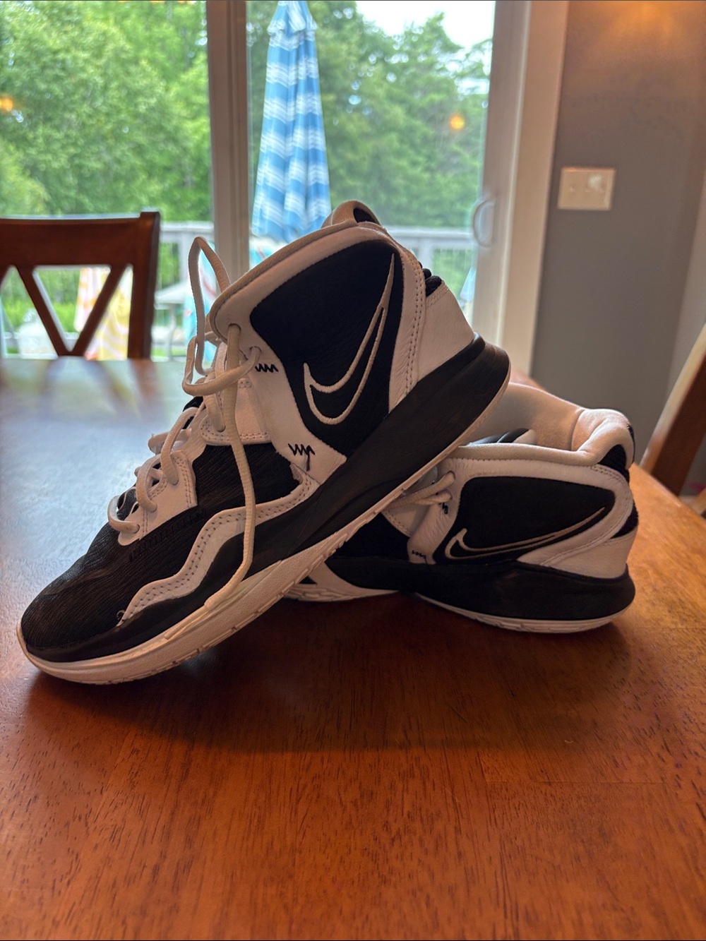 Nike Kyrie Black and White Mid-Top Athletic Sneakers